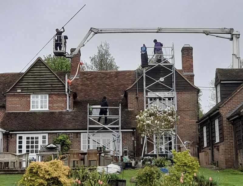 The Moss Cleaners using cherry picker and scaffolding to clean roof safely and professionally in Kingsbury, Warwickshire